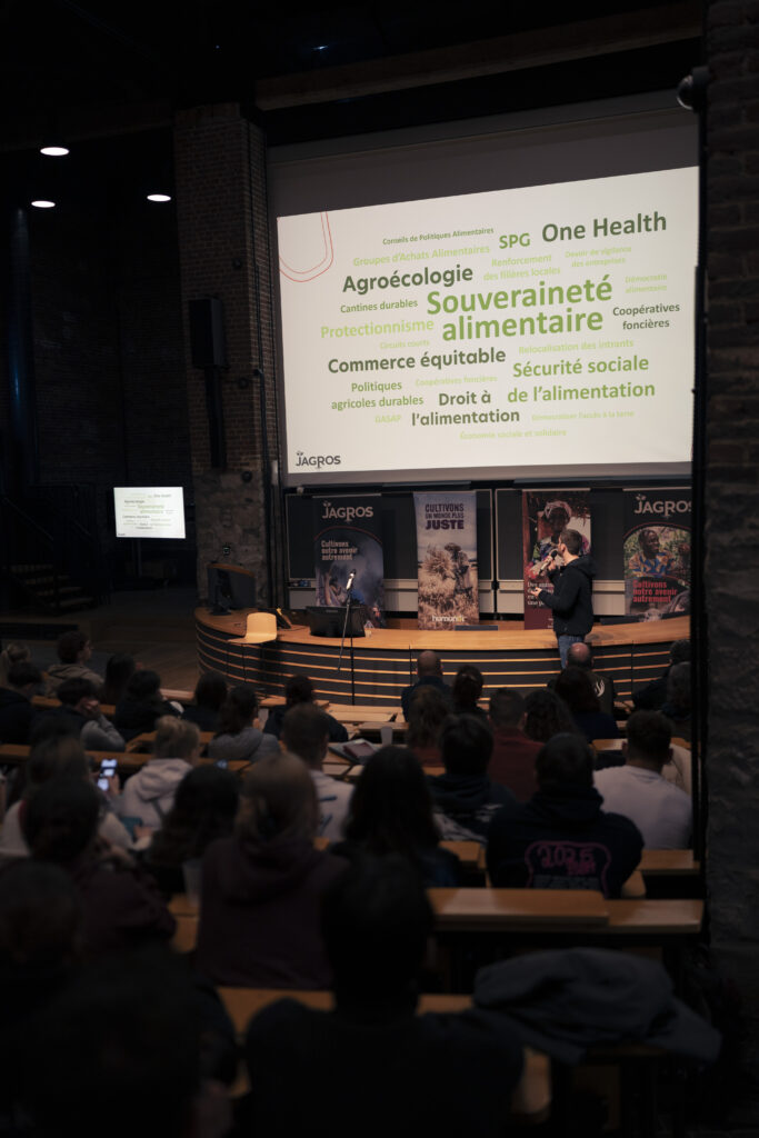 des élèves installés dans un auditoire regardant un écran où des information sont projetées